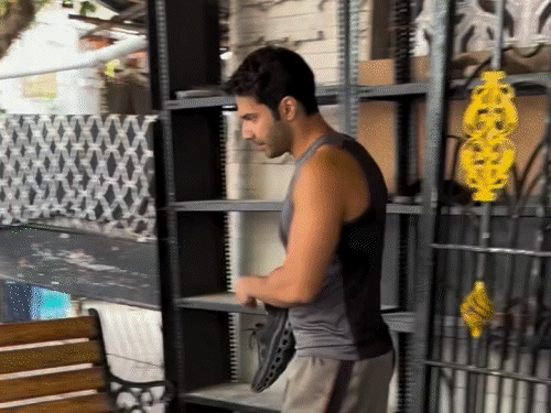 Varun Dhawan arrives at the temple in shorts and banyan: Questions were raised over the attire as the video went viral; Trolls said, 'I used to wear good clothes in God's house'.
